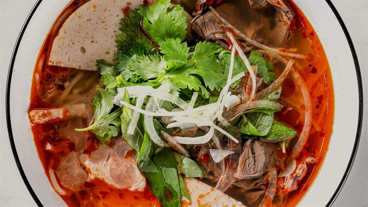 A bowl of Bún Bò Huế, spicy Vietnamese beef noodle soup